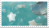 A stamp of a still image of blue slime with white star beads in it.